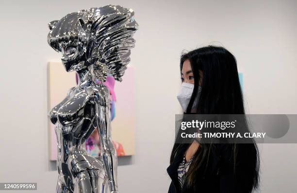 Gabriella Chu stands in front of artist Takashi Murakamis Avatar HIROPON Style, 2022 during a press preview May 11, 2022 for An Arrow through History...