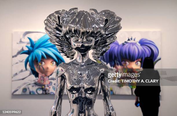 Person stands in front of artist Takashi Murakamis Avatar HIROPON Style, 2022 during a press preview May 11, 2022 for An Arrow through History at...