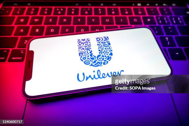 In this photo illustration, a Unilever logo is displayed on the screen of a smartphone.