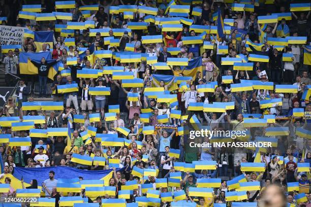 Supporter of Ukraine raise Ukraine flags during the friendly football match between German first division Bundesliga club Borussia Moenchengladbach...