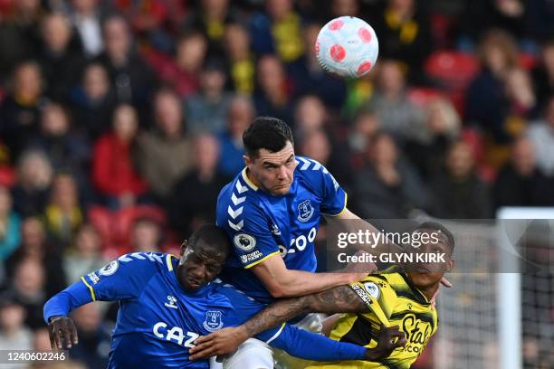 Everton's French midfielder Abdoulaye Doucoure, Everton's English defender Michael Keane and Watford's Brazilian striker Joao Pedro fight for the...