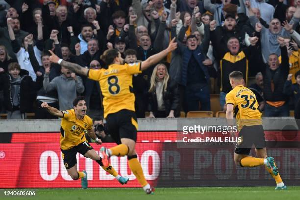 Wolverhampton Wanderers' Belgian midfielder Leander Dendoncker celebrates with Wolverhampton Wanderers' Portuguese midfielder Pedro Neto after...