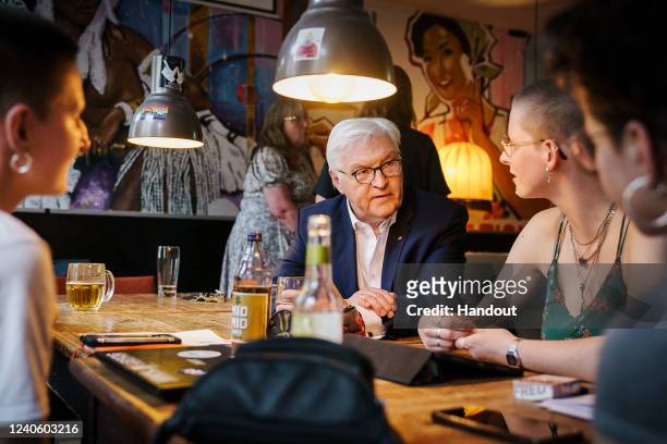 In this handout photo provided by the German Government Press Office , German President Frank-Walter Steinmeier meets with locals at the...
