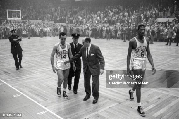 Finals: Boston Celtics Bob Cousy (14, Head Coach Red Auerbach, and Bill Russell walk off the court vs St. Louis Hawks at Boston Garden. Boston, MA...