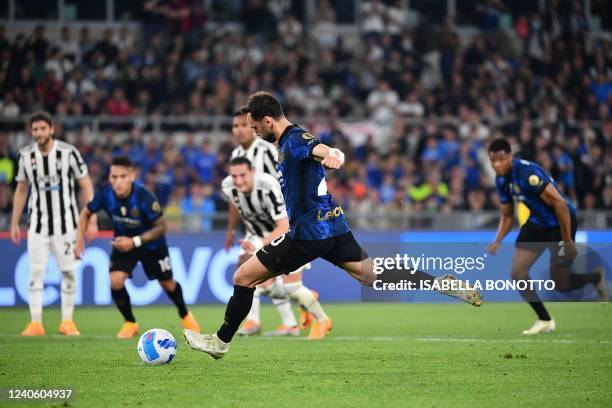 Inter Milan's Turkish midfielder Hakan Calhanoglu shoots to score a penalty during the Italian Cup final football match between Juventus and Inter on...