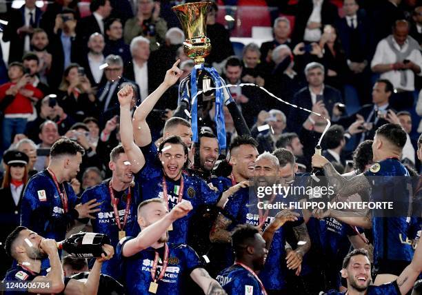 Inter players celebrate with the winner's trophy after Inter won the Italian Cup final football match between Juventus and Inter on May 11, 2022 at...