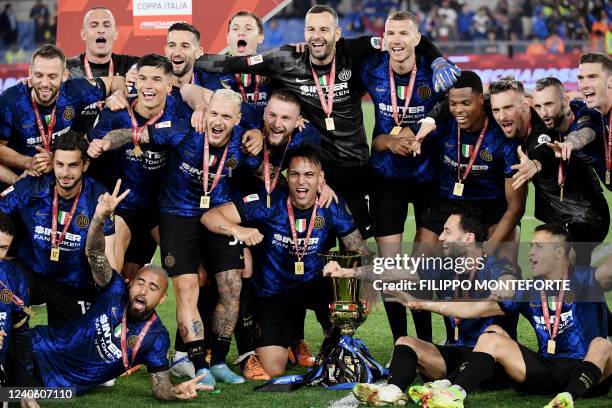 Inter Milan's Argentine forward Lautaro Martinez and Inter players celebrate with the winner's trophy after winning the Italian Cup final football...