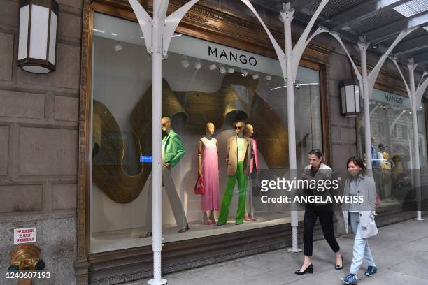 People walk past the newly opened flagship store for Barcelona-based clothing company Mango on May 11, 2022 in New York City. - The store has a...