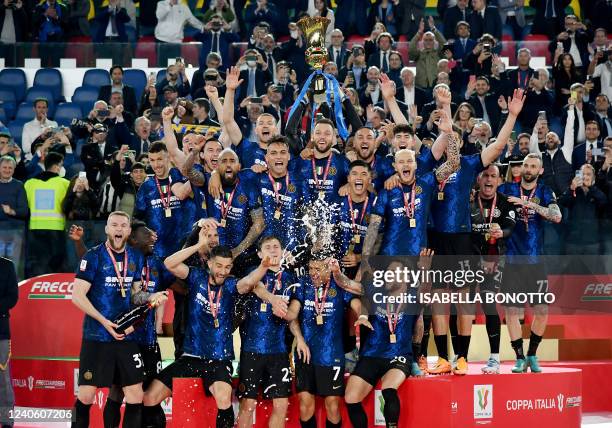Inter players celebrate with the winner's trophy after Inter won the Italian Cup final football match between Juventus and Inter on May 11, 2022 at...