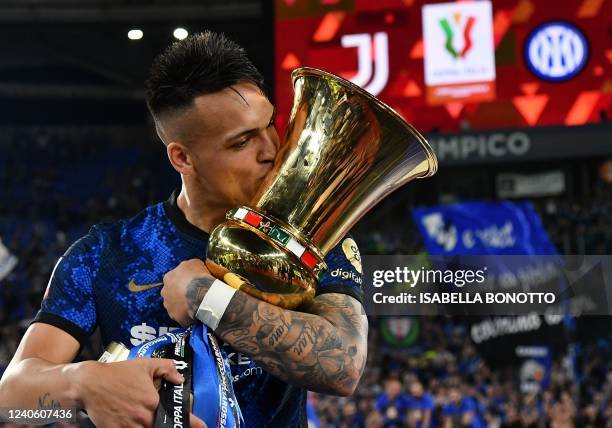 Inter Milan's Argentine forward Lautaro Martinez kisses the winner's trophy after Inter won the Italian Cup final football match between Juventus and...