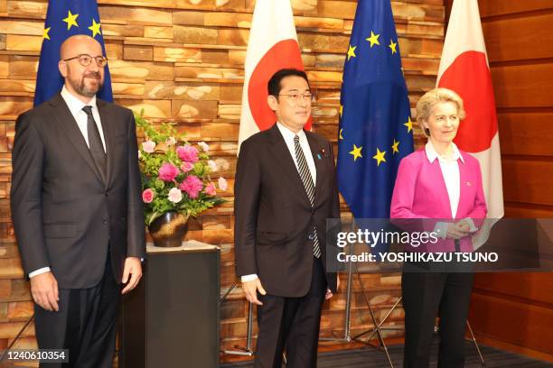 European Commission President Ursula von der Leyen and European Council President Charles Michel pose for photos with Japanese Prime Minister Fumio...