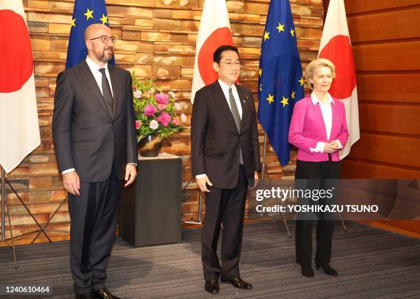European Commission President Ursula von der Leyen and European Council President Charles Michel pose for photos with Japanese Prime Minister Fumio...