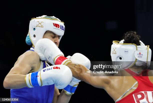 Lozada Motta of Porto Rico in action against Staneva Seetlena of Bulgaria during the first round of women's 54 kg qualifying match on the third day...