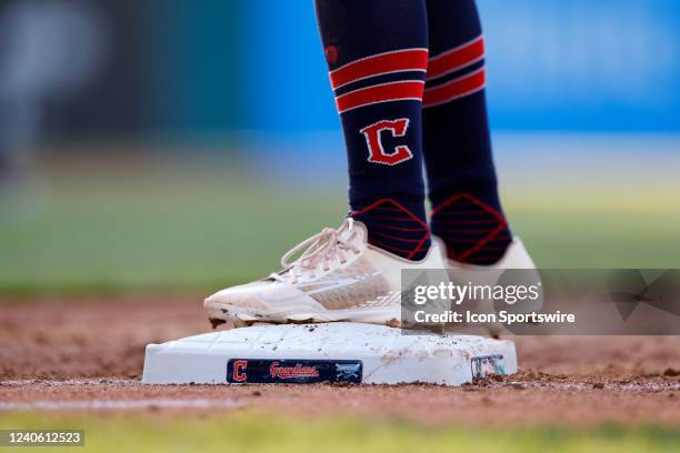 Detail view of Cleveland Guardians logo as a player stands on the first base bag during game two of an MLB doubleheader against the Toronto Blue Jays...