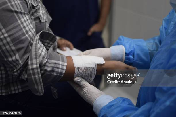 Nurse Jaqueline Mendoza aids a patient in the Salvadoran Red Cross emergency room, in San Salvador, El Salvador, on May 11, 2022. Every May 12,...