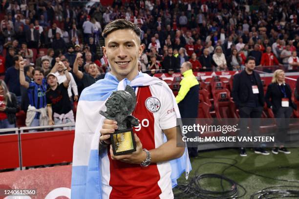 Ajax's Lisandro Martinez poses with the Rinus-Michels player of the year award after Ajax won the 36th Dutch Eredivisie title after the football...