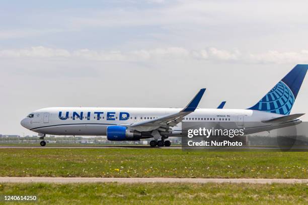 United Airlines Boeing 767-300 aircraft as seen departing from Amsterdam Schiphol Airport AMS EHAM. The wide body commercial airplane jet, is passing...