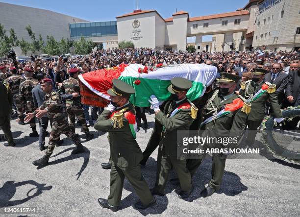 Palestinian honour guard carry the coffin of veteran Al-Jazeera journalist Shireen Abu Akleh following a state funeral at the presidential...