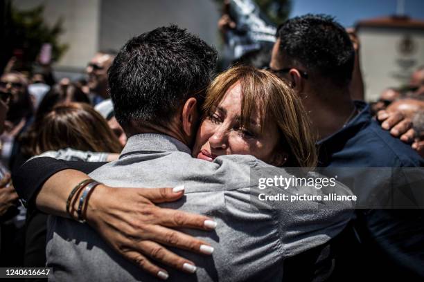May 2022, Palestinian Territories, Ramlaah: Palestinian journalist Givara Budeiri embraces a colleague during the state funeral of Al Jazeera...