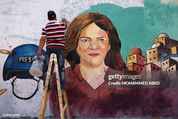 Palestinian artists paint a mural in honour of slain veteran Al-Jazeera journalist Shireen Abu Akleh in Gaza City on May 12, 2022. Abu Akleh, who was...