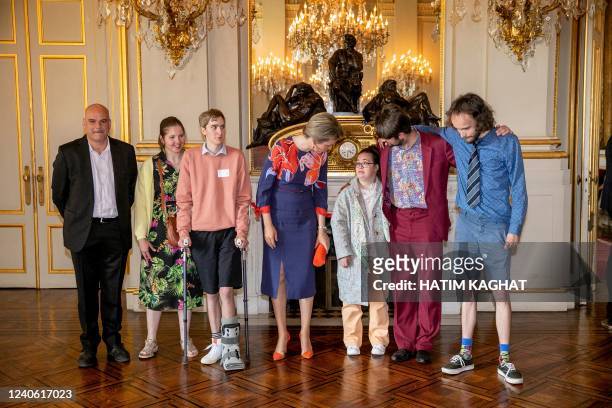Queen Mathilde of Belgium poses for a family photo at a ceremony to award the Queen Mathilde Award 2022 'I SEE, IDEA, I DO' of the Queen Mathilde...