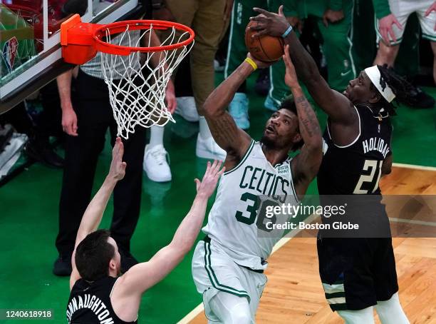 With the Milwaukee Bucks holding onto a 108-107 lead, guard Jrue Holiday swoops in to block a driving layup attempt by Boston Celtics guard Marcus...