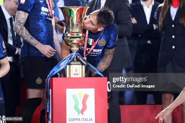 Lautaro Martinez of FC Internazionale kiss the Coppa Italia trophy after the Coppa Italia Final match between Juventus and FC Internazionale at...