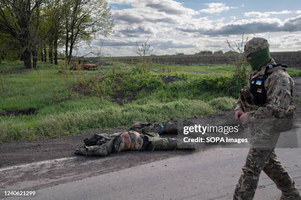 Military forensic investigator checks the streets and surroundings in search of bombs left by the Russians in the village of Vil'khivka. In the...