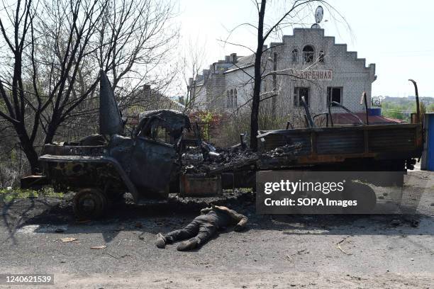 Body of dead Russian soldier lying on the street next to a Russian truck in the Vil'khivka village. According to forensic doctors the bodies has been...