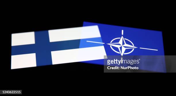 Flags of Finland and NATO are seen displayed on phone screens in this multiple exposure illustration photo taken in Krakow, Poland on May 12, 2022.