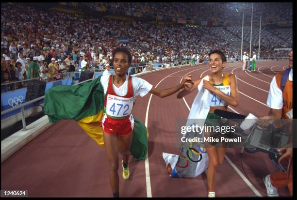 DERARTU TULU OF ETHIOPIA AND ELANA MEYER OF SOUTH AFRICA RUN A LAP OF HONOUR AFTER CLAIMING FIRST AND SECOND PLACE IN THE WOMENS 10000 METRE FINAL AT...