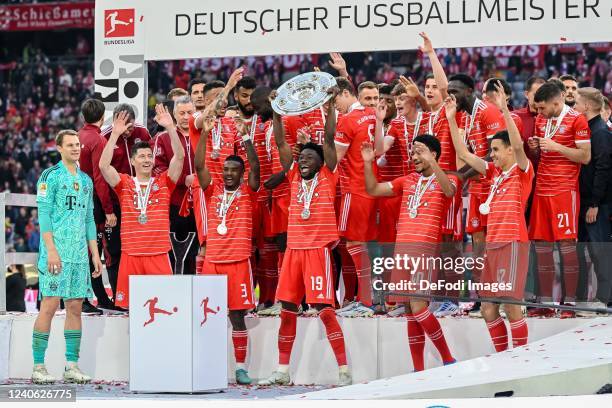 Alphonso Davies of Bayern Muenchen with championship trophy after the Bundesliga match between FC Bayern München and VfB Stuttgart at Allianz Arena...