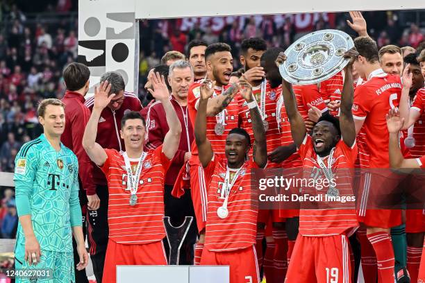 Alphonso Davies of Bayern Muenchen with championship trophy after the Bundesliga match between FC Bayern München and VfB Stuttgart at Allianz Arena...