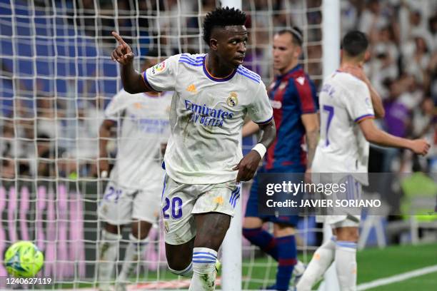 Real Madrid's Brazilian forward Vinicius Junior celebrates scoring his team's fourth goal during the Spanish league football match between Real...