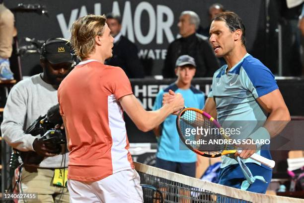 Canada's Denis Shapovalov and Spain's Rafael Nadal shake hands after Shapovalov won their third round match at the ATP Rome Open tennis tournament on...