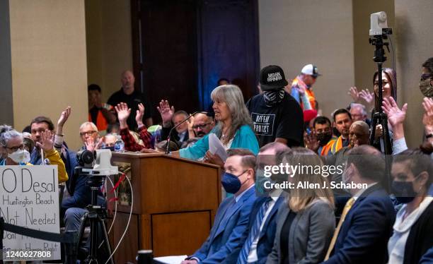 Costa Mesa, CA Attendees show their approval with hands in the air as Alelia Sandoval, spiritual advisor for the Acjachemen Nation, speaks at the...
