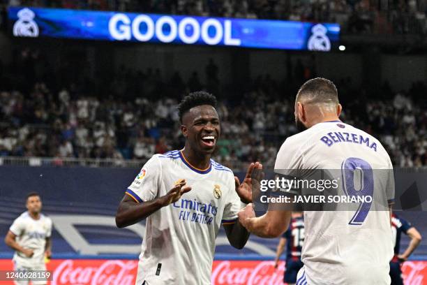 Real Madrid's Brazilian forward Vinicius Junior celebrates with Real Madrid's French forward Karim Benzema after scoring his team's fifth goal during...