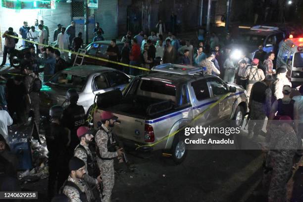 Pakistani security officials gather at the site of bomb blast in Karachi, Pakistan on May 12, 2022. At least one killed, 13 injured in powerful blast...