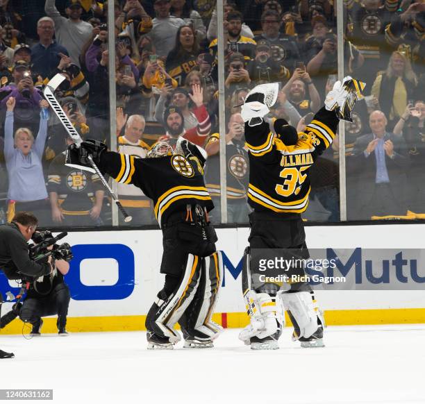 Jeremy Swayman of the Boston Bruins and teammate Linus Ullmark celebrate after a 5-2 victory against the Carolina Hurricanes in Game Six of the First...