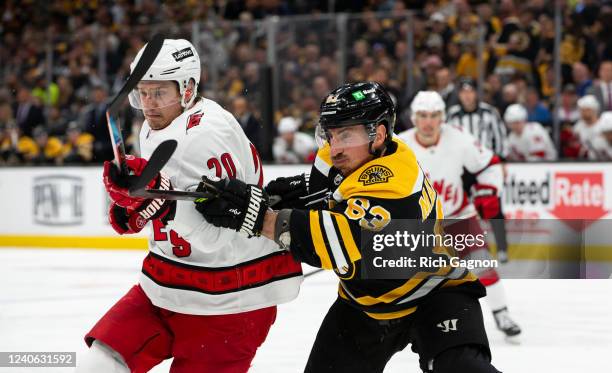 Brad Marchand of the Boston Bruins checks Sebastian Aho of the Carolina Hurricanes during the second period in Game Six of the First Round of the...