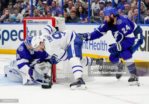 Tampa Bay Lightning goaltender Andrei Vasilevskiy makes a stick poke save as Toronto Maple Leafs center John Tavares toys to score the wrap around...