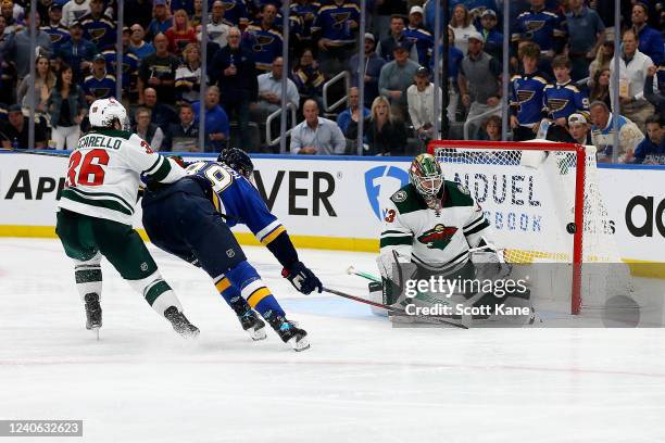 Cam Talbot of the Minnesota Wild defends the net from a shot on goal by Pavel Buchnevich of the St. Louis Blues during the third period in Game Six...