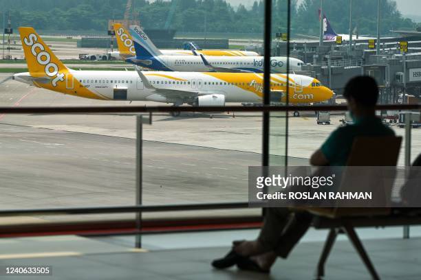 Passenger planes are seen parked at Singapore Changi Airport in Singapore on May 13, 2022.