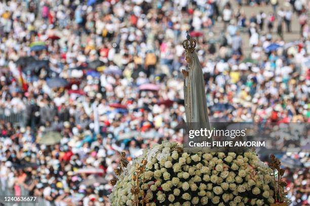 Statue of Our Lady of Fatima is pictured during a procession at the Shrine of Fatima, central Portugal, on May 13, 2022. - Thousands of pilgrims...