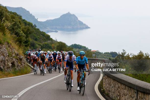 The pack rides past the Punta della Matrella near Maratea during the 7th stage of the Giro d'Italia 2022 cycling race, 196 kilometers between...
