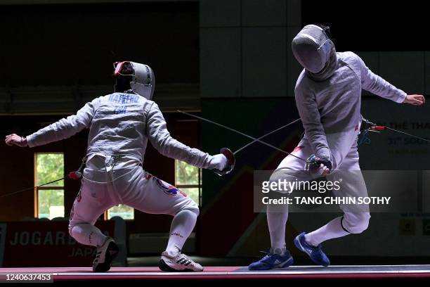 Vietnam's Vu Thanh An competes with Thailand's Ruangrit Haekerd in the men's sabre individual fencing semi-final during the 31st Southeast Asian...