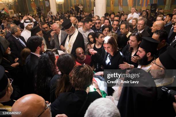 Family and relatives pray collectively in a church in the old city during the funeral of Al Jazeera reporter Shireen Abu Akleh on May 13, 2022 in...