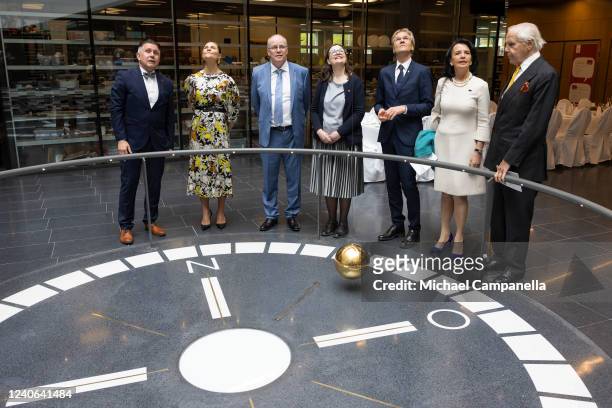 Crown Princess Victoria of Sweden looks at a pendulum during the inauguration of the new Angstrom laboratory at Uppsala University on May 13, 2022 in...