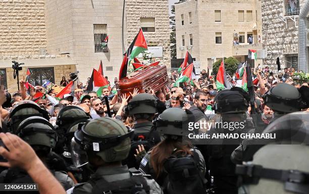 Violence erupts between Israeli security forces and Palestinian mourners carrying the coffin of slain Al-Jazeera journalist Shireen Abu Akleh out of...