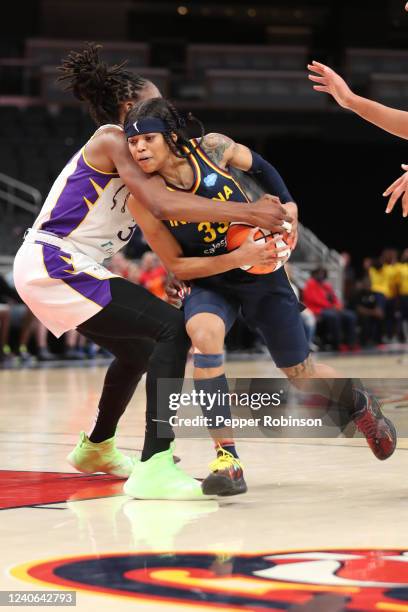 Destanni Henderson of the Indiana Fever handles the ball during the game against the Los Angeles Sparks at Gainbridge Fieldhouse on May 8, 2022 in...